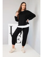 Dámský komplet s máslovou barvou, volnou mikinou a tepláky černý Dámský komplet s máslovou barvou, volnou mikinou a tepláky černý