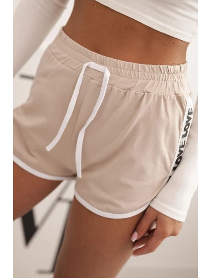 Dámské bavlněné šortky s elastickým pasem a sportovním lemem béžové Dámské bavlněné šortky s elastickým pasem a sportovním lemem béžové