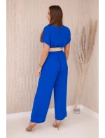 Kombinéza s ozdobným páskem v pase chrpově modrá Kombinéza s ozdobným páskem v pase chrpově modrá