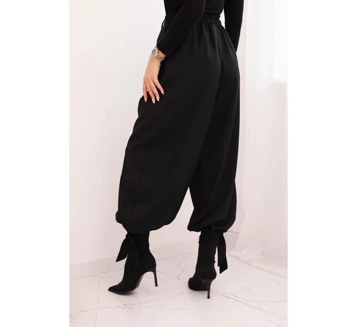 Dámské kalhoty s širokou nohavicí a zavazováním dole černé Dámské kalhoty s širokou nohavicí a zavazováním dole černé