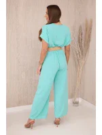 Kombinéza s ozdobným páskem v pase světle mátová Kombinéza s ozdobným páskem v pase světle mátová