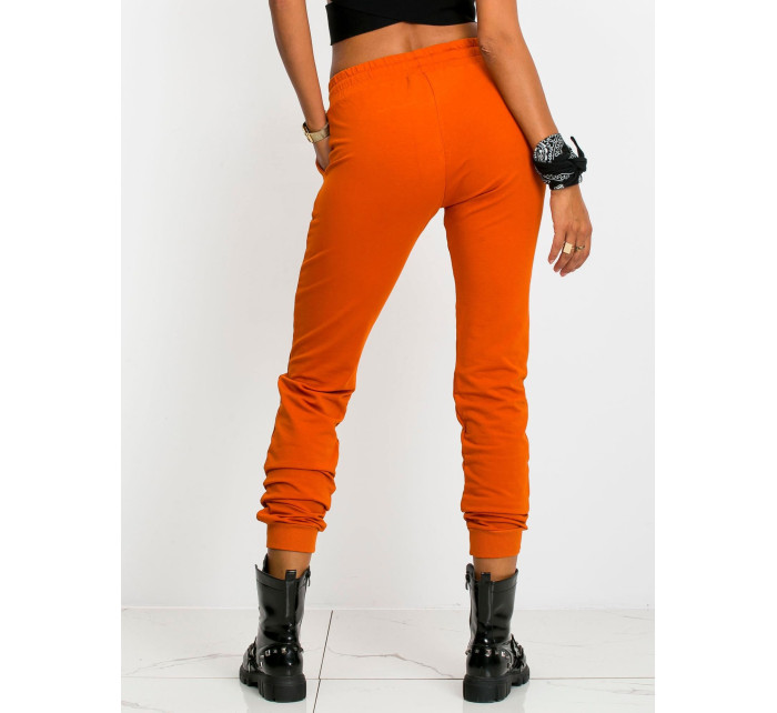 Tmavě oranžové kalhoty Faster