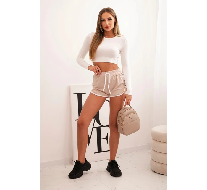Dámské bavlněné šortky s elastickým pasem a sportovním lemem béžové Dámské bavlněné šortky s elastickým pasem a sportovním lemem béžové
