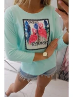 Halenka s 3D grafikou plameňáka v mátové barvě