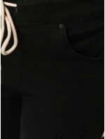 Černé dámské kalhoty FashionStreet s dírou UY2857 Černé dámské kalhoty FashionStreet s dírou UY2857