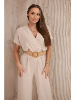 Kombinéza s ozdobným páskem v pase béžová