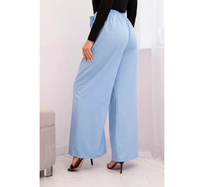 Dámské elegantní kalhoty s širokou nohavicí a ozdobným květem modré Dámské elegantní kalhoty s širokou nohavicí a ozdobným květem modré