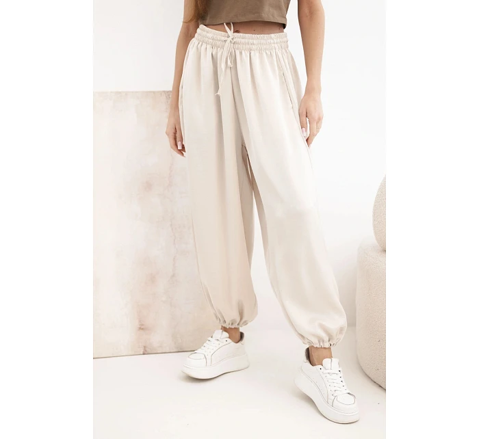 Široké dámské kalhoty s gumou v pase a typu béžové model 22064415 - K-Fashion Široké dámské kalhoty s gumou v pase a typu béžové model 22064415 - K-Fashion
