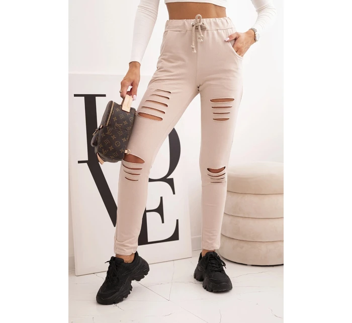 Dámské kalhoty z bavlny s roztržením a gumou v pase béžové