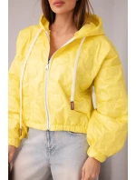 Dámská prošívaná bunda s kapucí a ozdobným květinovým model 21998368 žlutá - K-Fashion