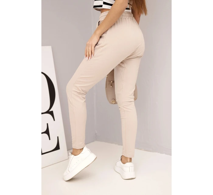 Dámské tepláky s elastickým pasem a šňůrkou béžové Dámské tepláky s elastickým pasem a šňůrkou béžové