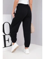 Dámské kalhoty z bavlny s vysokým pasem a ozdobným knoflíkem černé Dámské kalhoty z bavlny s vysokým pasem a ozdobným knoflíkem černé