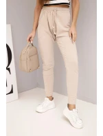 Dámské tepláky s elastickým pasem a šňůrkou béžové Dámské tepláky s elastickým pasem a šňůrkou béžové